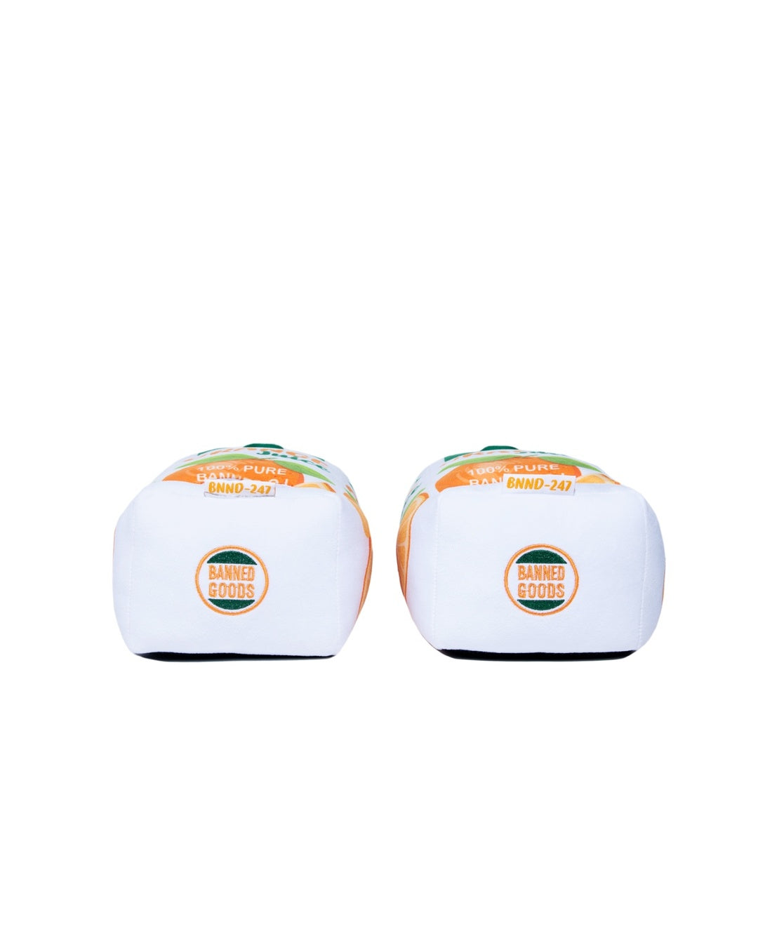A pair of plush slippers shown from the rear, featuring orange and green graphics on the deck tops and circular 'Banned Goods' logos on the backplates.